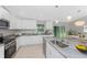 Bright kitchen with granite counters, stainless steel appliances, and white cabinetry at 4863 Las Almanos Ave, North Port, FL 34288