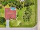 Overhead shot of house with screened pool, red tile roof, long driveway, and well-manicured green lawn at 510 Border St, Port Charlotte, FL 33953