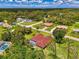 Aerial view of the property highlighting the lush surroundings, sparkling pool, and the desirable neighborhood at 510 Border St, Port Charlotte, FL 33953