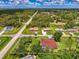 Aerial view showcases the property, surrounding neighborhood, and lush landscaping, offering a sense of location and privacy at 510 Border St, Port Charlotte, FL 33953