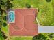 Aerial view showcasing roof, screened pool, and lush backyard with beautiful landscaping at 510 Border St, Port Charlotte, FL 33953