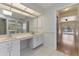 Spacious bathroom with dual sinks, a glass-door shower and connecting view to the pool patio at 510 Border St, Port Charlotte, FL 33953