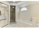 Bright bathroom with a glass-door shower, tub, and mirrored closet at 510 Border St, Port Charlotte, FL 33953