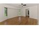 Bright main bedroom features hardwood floors, a ceiling fan and big windows with views to the outdoors at 510 Border St, Port Charlotte, FL 33953