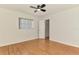 Comfortable bedroom featuring a window and light hardwood floors, illuminated by a modern ceiling fan at 510 Border St, Port Charlotte, FL 33953