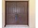 Elegant, dark wood double doors create a grand entrance to the home at 510 Border St, Port Charlotte, FL 33953