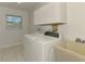 Laundry room with a washer, dryer, utility sink, and ample storage space at 510 Border St, Port Charlotte, FL 33953