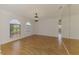Living room boasts natural light with wood floors and modern light fixture at 510 Border St, Port Charlotte, FL 33953