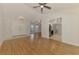 Spacious living area with wood flooring, a ceiling fan, and a view of the kitchen and dining area at 510 Border St, Port Charlotte, FL 33953