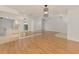 Open-concept living room boasts wood floors, a kitchen view, and ample natural light at 510 Border St, Port Charlotte, FL 33953