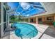 Screened-in lanai features a sparkling pool and outdoor living space adjacent to the home at 510 Border St, Port Charlotte, FL 33953