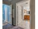 Well lit bathroom with tile floors, wood cabinets, shower and toilet at 6562 Hikina Dr, North Port, FL 34287