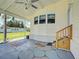 Spacious covered carport featuring a ceiling fan, door to home, and a decorative stone-paved patio at 6562 Hikina Dr, North Port, FL 34287