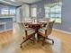 Cozy dining area with a wooden table, four chairs, and bright natural light at 6562 Hikina Dr, North Port, FL 34287