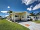 Charming single-story home featuring a covered carport and well-maintained landscaping and stone-paved driveway at 6562 Hikina Dr, North Port, FL 34287