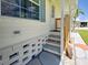 Inviting front porch with painted steps, a wooden railing, and a screen door at 6562 Hikina Dr, North Port, FL 34287