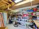 Well-organized garage with wooden beams, ample storage, and tools on shelves at 6562 Hikina Dr, North Port, FL 34287