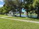 White gazebo with park benches near a lake surrounded by lush green trees at 6562 Hikina Dr, North Port, FL 34287