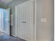 Hallway featuring a set of double doors at 6562 Hikina Dr, North Port, FL 34287