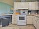 White kitchen with matching oven and light countertops at 6562 Hikina Dr, North Port, FL 34287