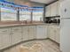 Functional kitchen featuring bright white cabinets, modern appliances, and stylish flooring at 6562 Hikina Dr, North Port, FL 34287