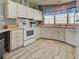 Well-maintained kitchen with ample cabinet space, modern appliances, and stylish flooring at 6562 Hikina Dr, North Port, FL 34287