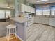 Bright kitchen featuring white cabinets, modern appliances, and a convenient breakfast bar at 6562 Hikina Dr, North Port, FL 34287
