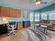 Cozy living room featuring natural light from bay window, stylish furniture, and a ceiling fan at 6562 Hikina Dr, North Port, FL 34287