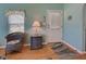 Charming living room with a comfortable wicker chair, window, with a view of the front door at 6562 Hikina Dr, North Port, FL 34287