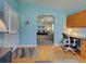 Inviting living room showcasing an open archway and stylish coastal decor. A desk and chair provide a workspace at 6562 Hikina Dr, North Port, FL 34287