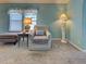 Inviting living room with coastal-themed decor, soft lighting, and a cozy armchair at 6562 Hikina Dr, North Port, FL 34287