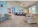 Open-concept living room featuring cozy seating, light-blue walls, and carpet at 6562 Hikina Dr, North Port, FL 34287