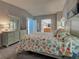 Bright bedroom showcasing a bed with unique bedding and ensuite bathroom at 6562 Hikina Dr, North Port, FL 34287