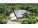Aerial view of the home with large lot, back patio and basketball court at 6594 Buckboard St, North Port, FL 34291