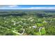 Aerial view showcasing the home's serene wooded setting and vast acreage at 6594 Buckboard St, North Port, FL 34291