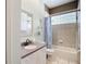 Bathroom features a single vanity and bathtub and block glass window for light at 6594 Buckboard St, North Port, FL 34291