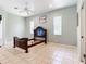 Serene bedroom with light blue walls, tiled floors, and ample natural light at 6594 Buckboard St, North Port, FL 34291