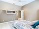 Neutral bedroom featuring a bed with colorful bedspread at 6594 Buckboard St, North Port, FL 34291