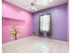 Pink and purple bedroom featuring a ceiling fan and one window at 6594 Buckboard St, North Port, FL 34291