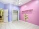Pink and purple bedroom with ceiling fan, with a closet at 6594 Buckboard St, North Port, FL 34291