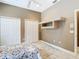 Neutral bedroom with two closets and a doorway to the next room at 6594 Buckboard St, North Port, FL 34291