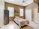 Neutral bedroom featuring two windows, a single bed and two closets at 6594 Buckboard St, North Port, FL 34291