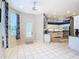 Open-concept breakfast nook with tile floors, white trim, and access to the kitchen at 6594 Buckboard St, North Port, FL 34291