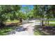 Private gated driveway leading to a secluded property surrounded by lush greenery at 6594 Buckboard St, North Port, FL 34291
