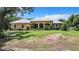 Charming single-story home with a metal roof and lush landscaping at 6594 Buckboard St, North Port, FL 34291