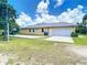 Exterior shot of home with a spacious three car garage and basketball hoop at 6594 Buckboard St, North Port, FL 34291