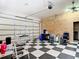 Organized garage with ample storage space, checkered flooring and an automatic door at 6594 Buckboard St, North Port, FL 34291