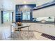 Bright kitchen with white cabinets, blue accent wall, and modern appliances at 6594 Buckboard St, North Port, FL 34291