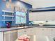 Close up of a bright kitchen featuring white cabinets and a blue accent wall at 6594 Buckboard St, North Port, FL 34291