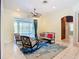 Cozy living room with ample seating and view of the screened lanai with a pool at 6594 Buckboard St, North Port, FL 34291